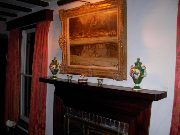 Interior of Cox Home with fireplace and painting above it.